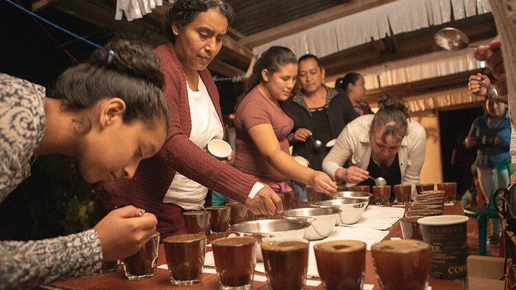 Female Chica Bean employees working around a table together.