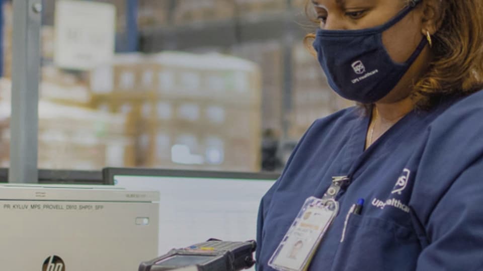 A UPS staffer labelling a Provell Pharmaceutical box