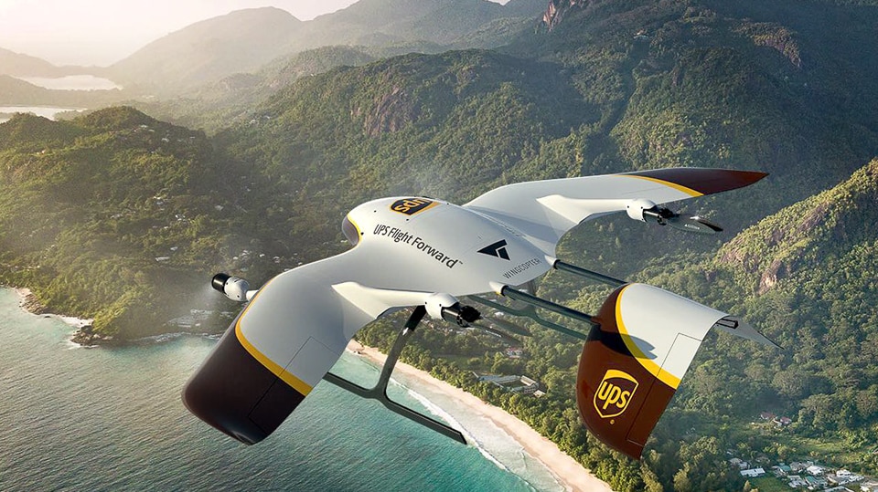 A UPS Wingcopter UAV drone delivers urgent healthcare supplies to a remote village.