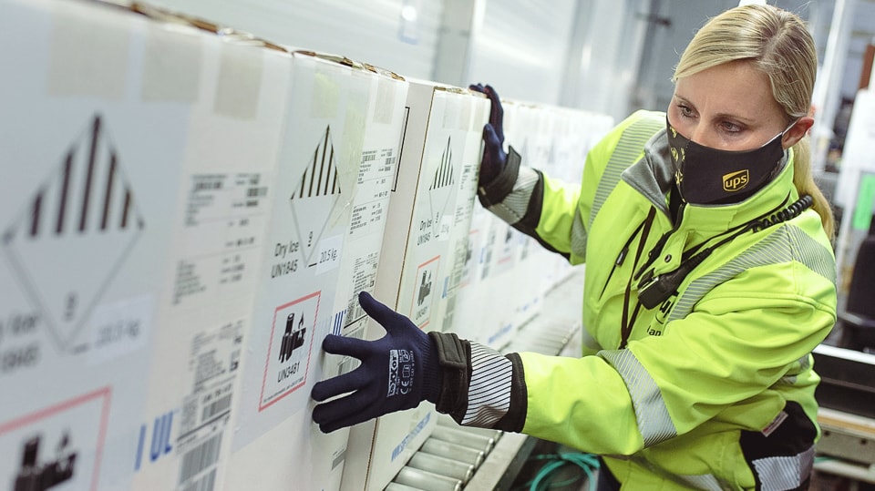 A UPS team member managing quality assurance in a cold chain storage facility.