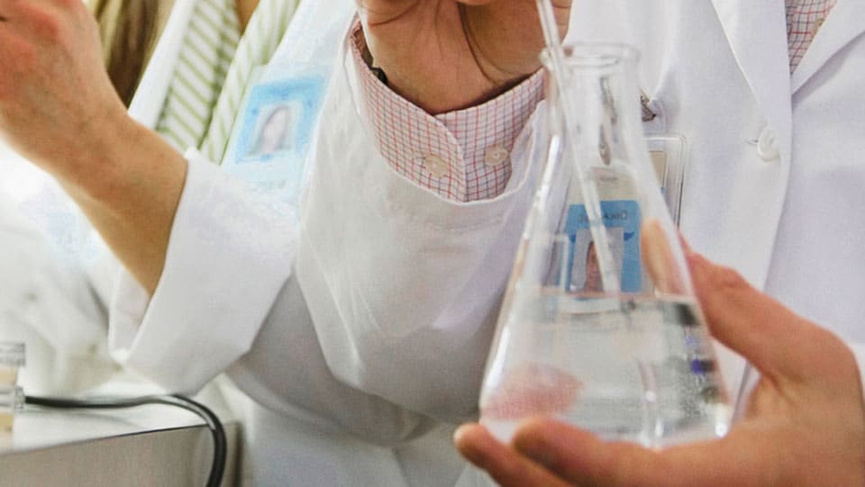 Two lab researchers running diagnostics tests