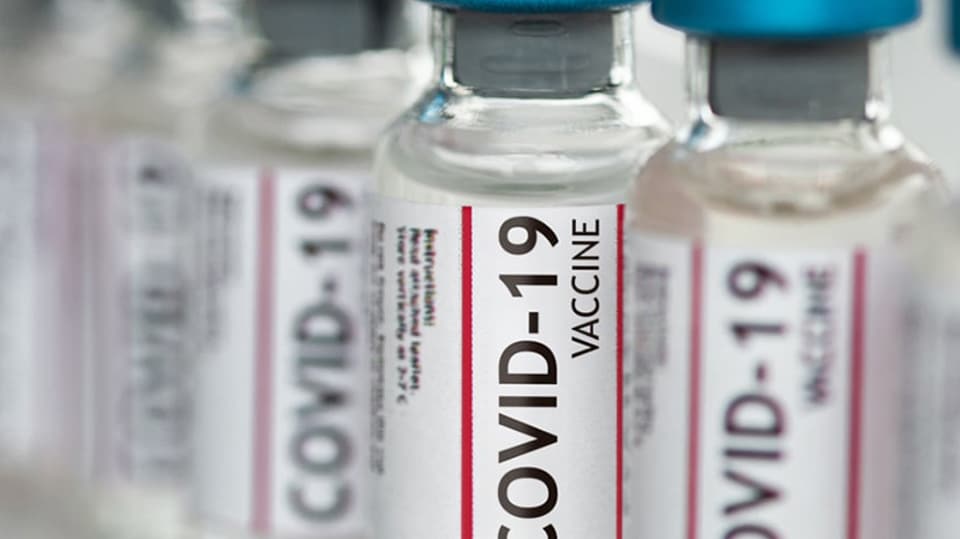 A row of COVID-19 vaccine vials