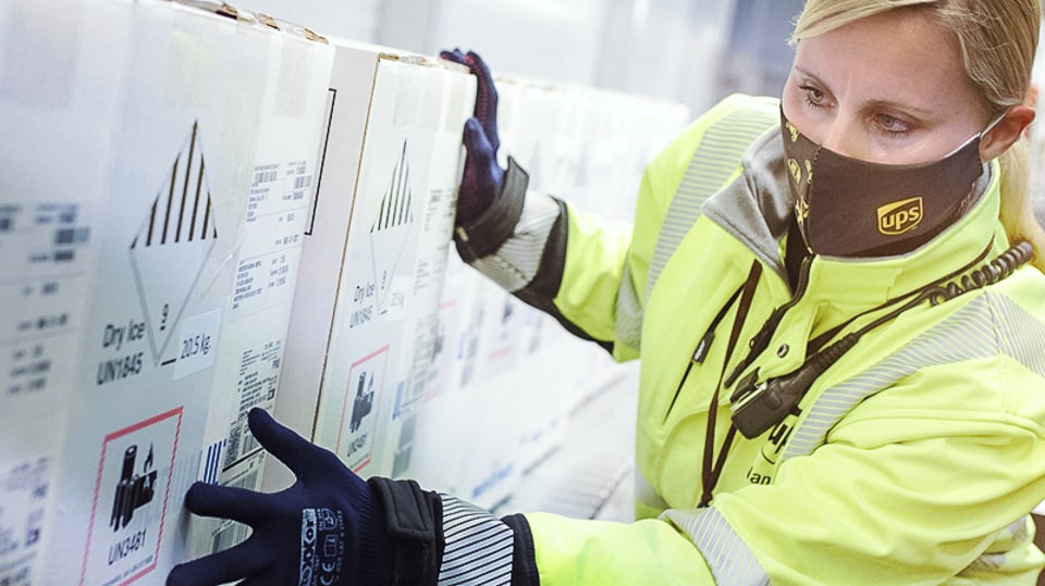 A UPS staffer examining a cold chain box.