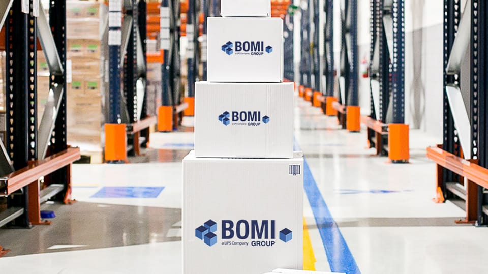 Stacked Bomi boxes in a warehouse.