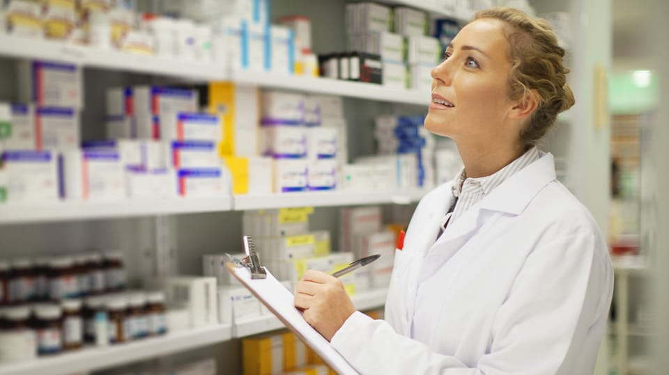 A pharmacist checking her inventory.