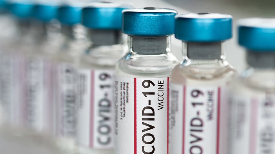 A row of COVID-19 vaccine bottles