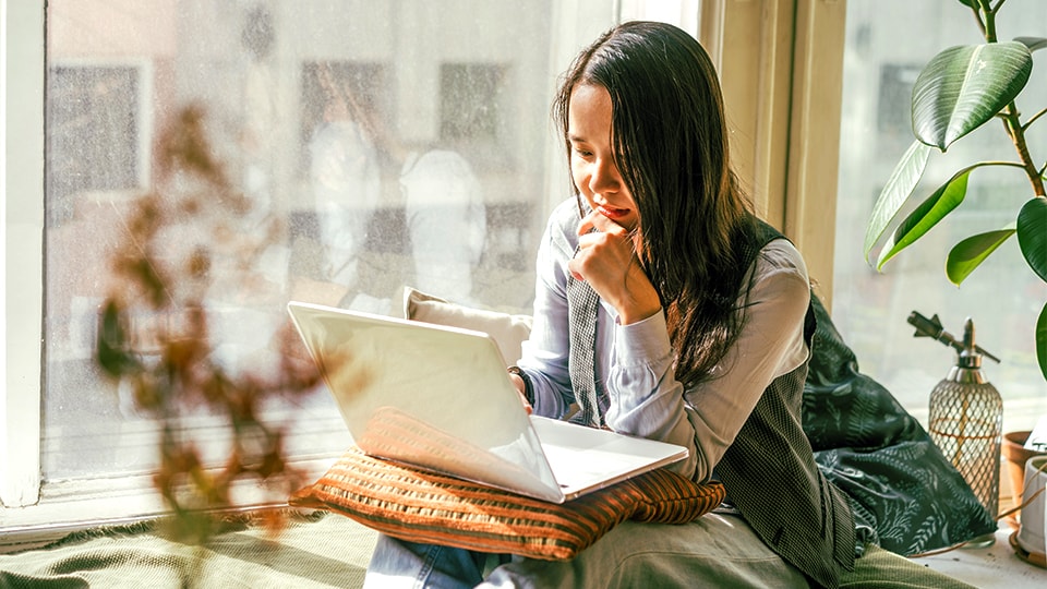 Female consumer tacking package on laptop