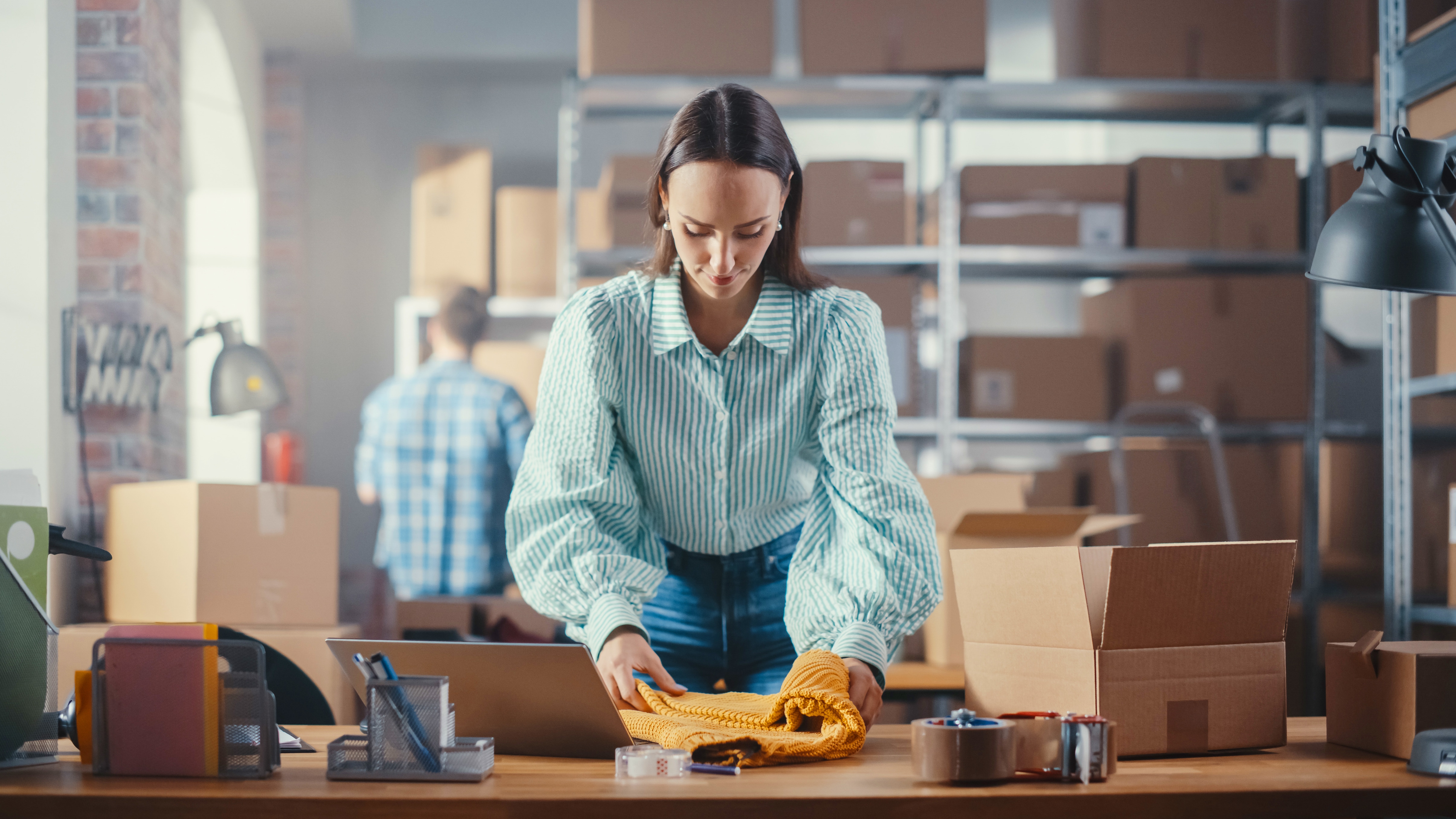 Small business woman preparing a U-P-S shipment for a customer.