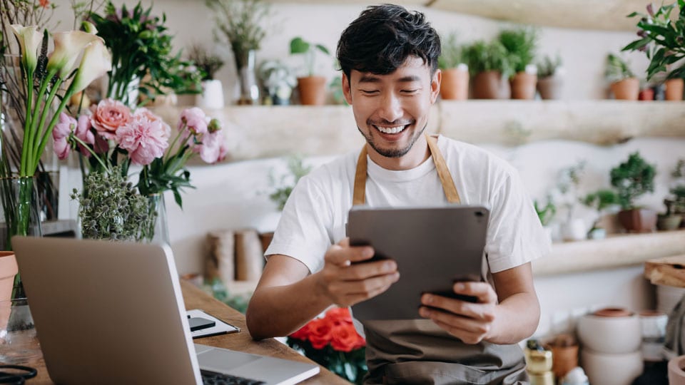 Man working on tablet smiling