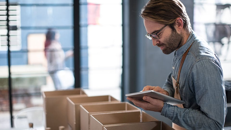 Business owner packing shipments