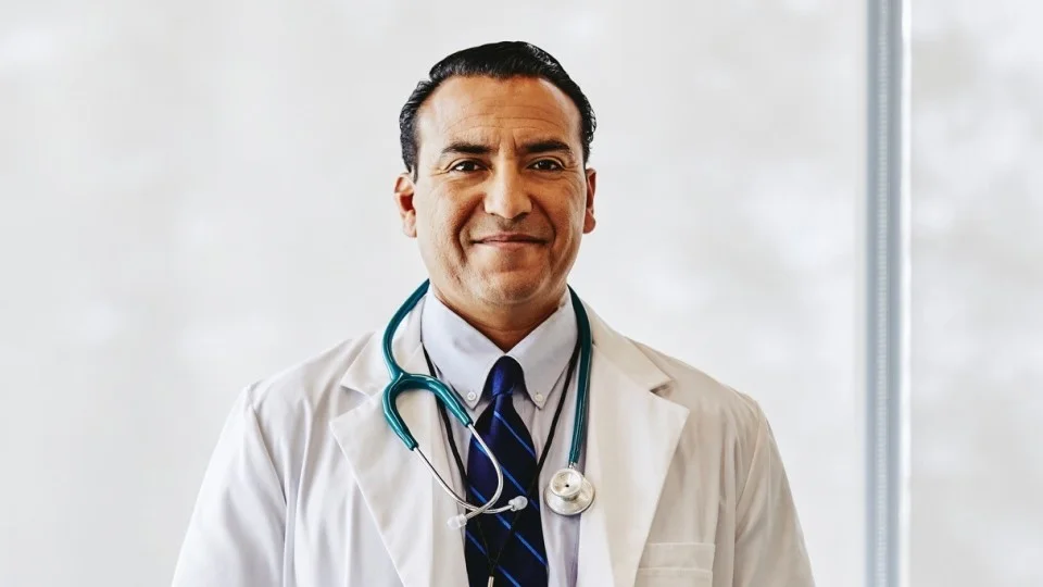 Male doctor in white coat and wearing stethoscope