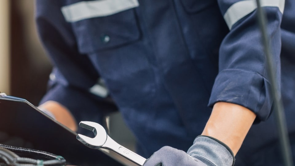 mecánico con llave en mano mientras identifica el problema