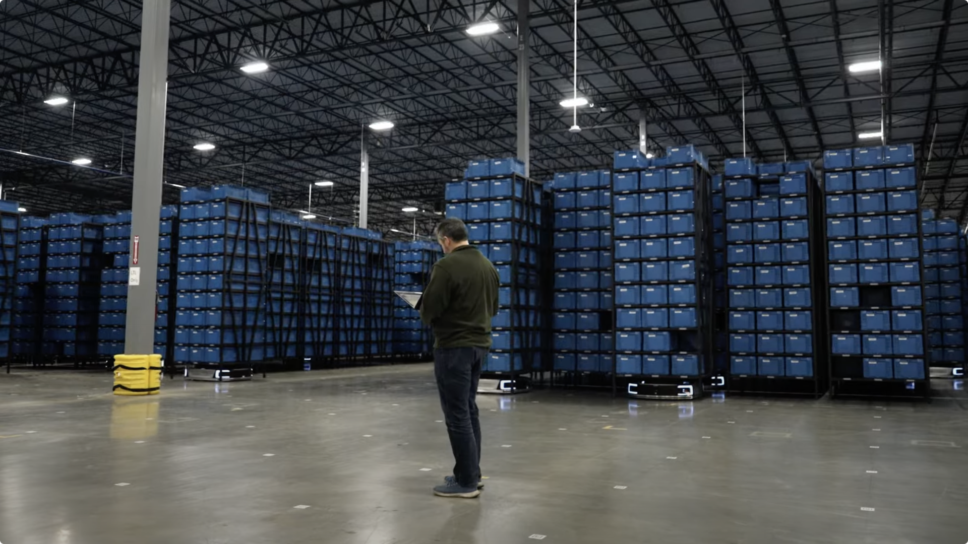 An logistics manager standing in the UPS Velocity warehouse with a laptop monitoring the performance