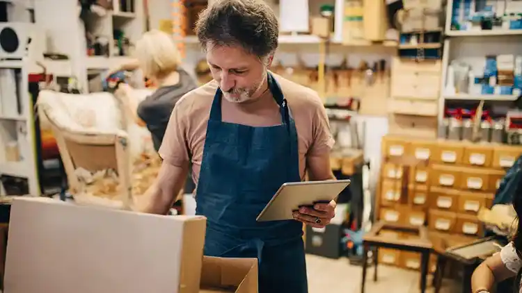 Small business owner preparing to ship wine