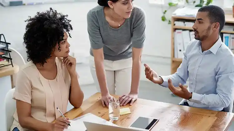 Three people having a meeting