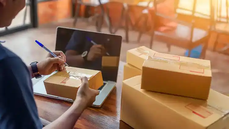 UPS business customer writing on package