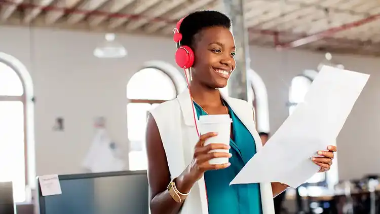 Femme avec des écouteurs examinant un document