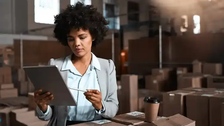 Person at a warehouse looking at their tablet