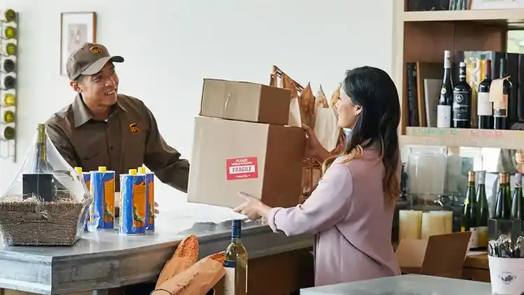 UPS driver collecting parcels in a shop