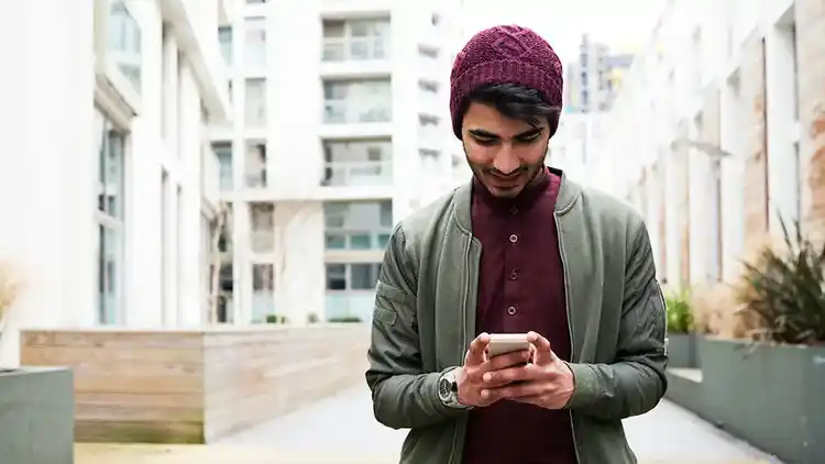 Man on mobile device using UPS My Choice