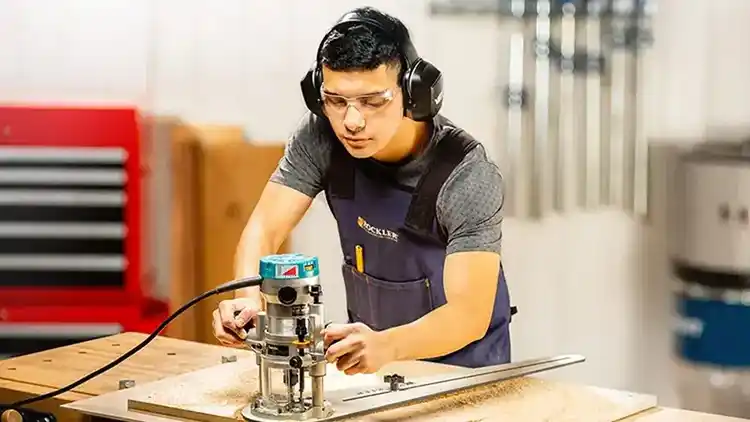 Man works to assemble item to ship.