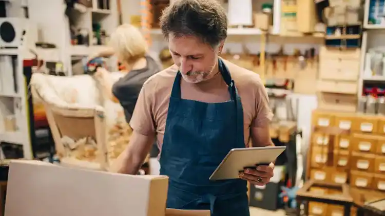 Man prepares parcel for cross border shipping