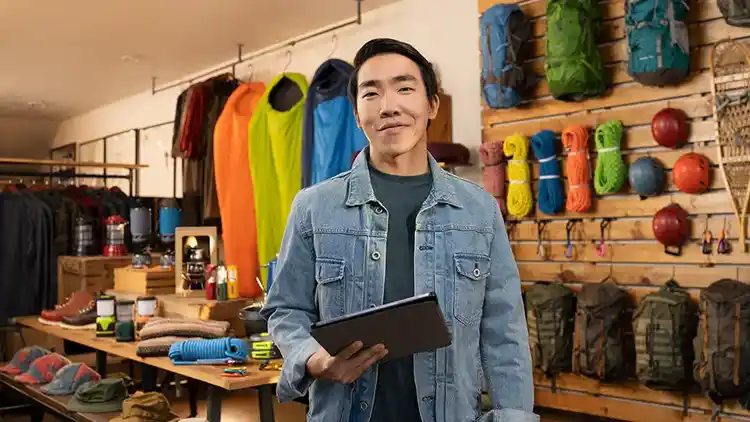 A man holding a tab in sports store