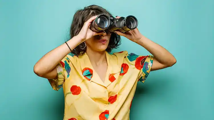 Woman looking through binoculars