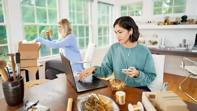 Woman on laptop in small office