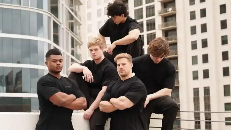 a group of people standing on a building rooftop