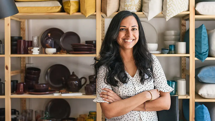 Person is posed in front of a dish shelf.