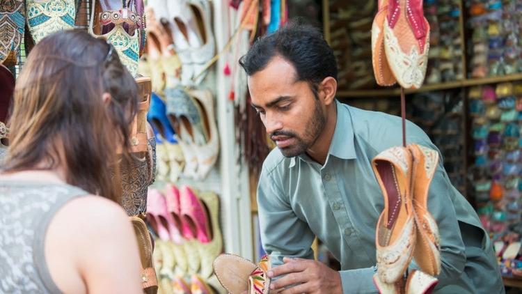 Man selling shoes to a woman