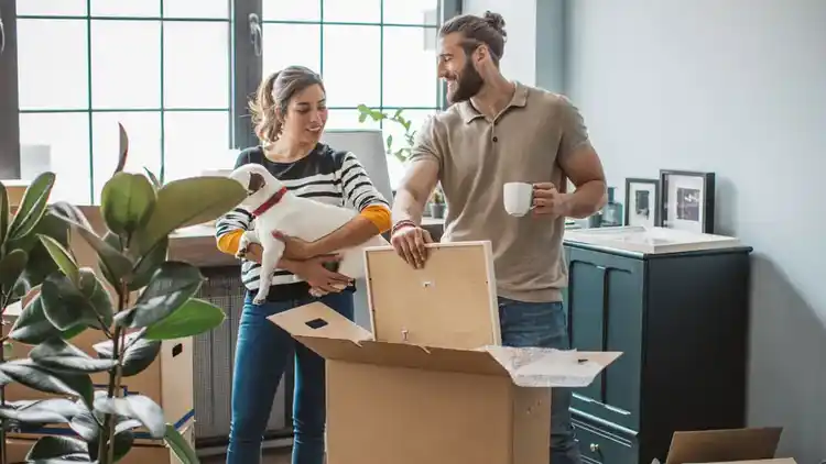 a couple and their dog preparing to ship with UPS