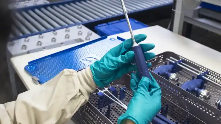 Healthcare worker handling medical equipment