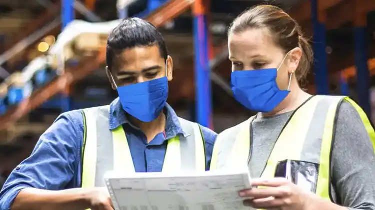 Two UPS Healthcare workers in a warehouse