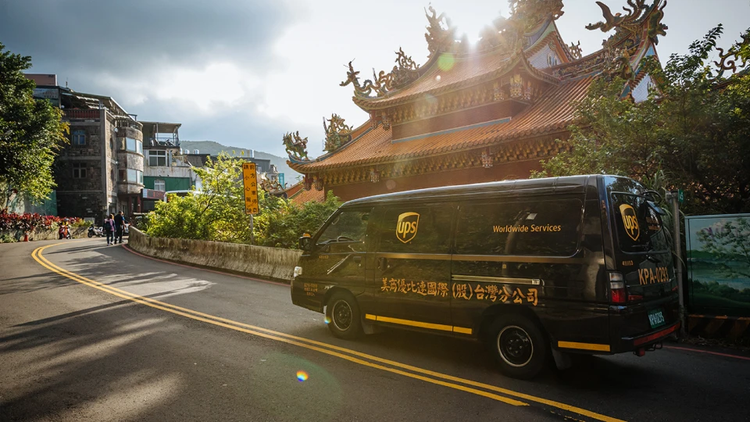 A UPS van driving on the road