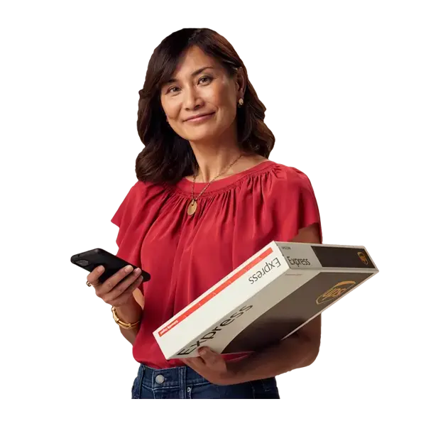 Woman holding large moving boxes while smiling