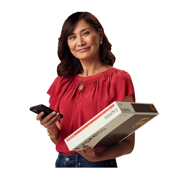 Woman holding large moving boxes while smiling