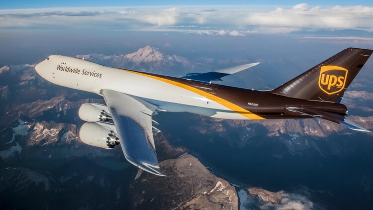 U-P-S airplane flying over a mountain