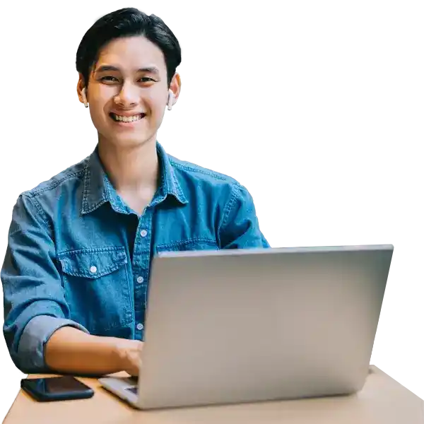 a smiling person at their computer