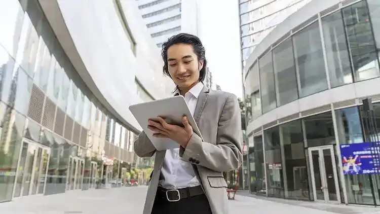 a businessperson reviewing their tablet