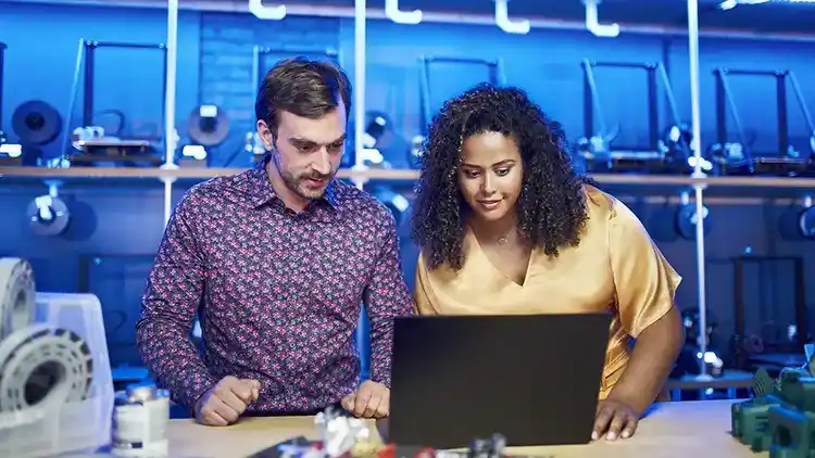 2 persons looking at the laptop