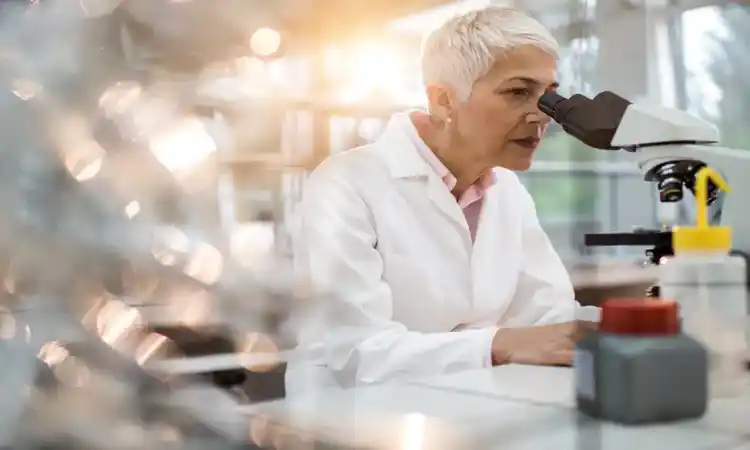 Woman looking through a microscope